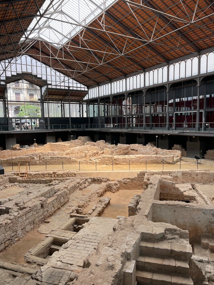 Intricate Roman ruins displayed inside a modern museum in Barcelona, Spain.