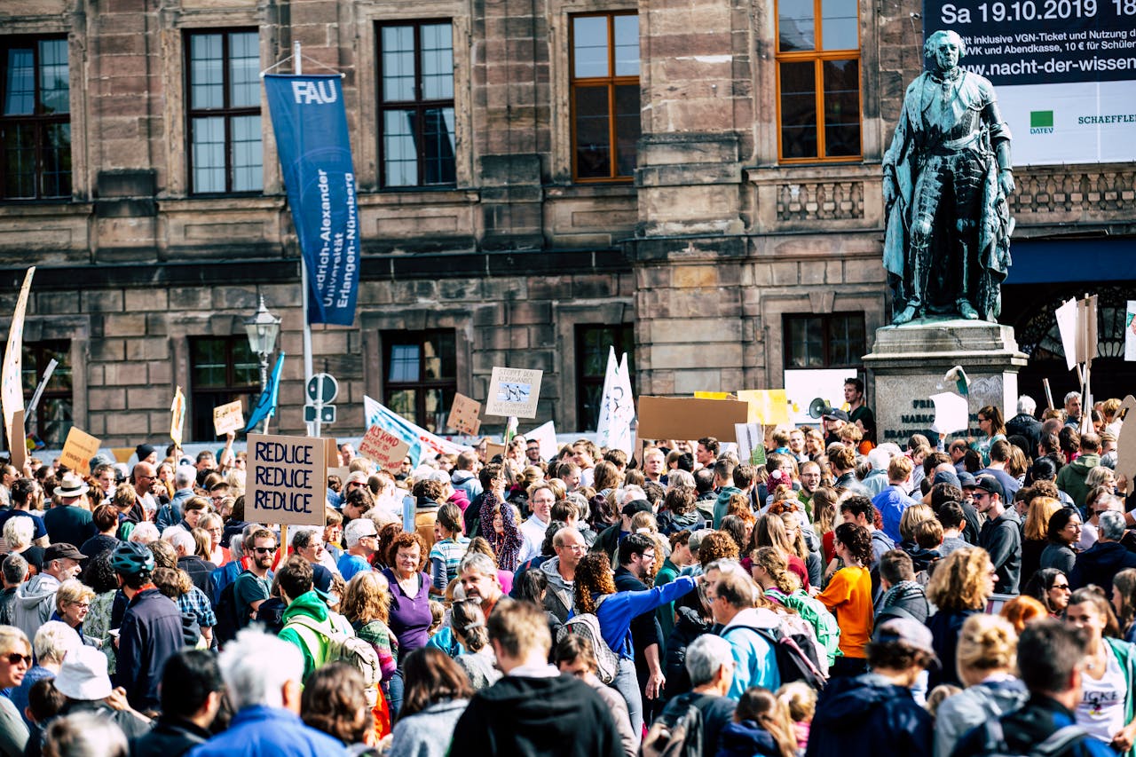 Vibrant crowd gathered in Strasbourg protesting climate change under clear skies.